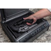 Image of Hand placing a handgun into the Hornady RAPiD® Safe Keypad Handgun Vault with RFID technology for secure storage.